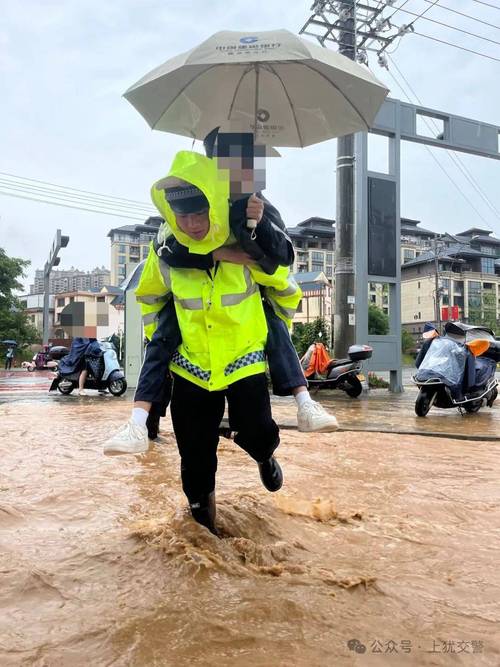 郑州暴雨交警蹚深水抱孩子过马路